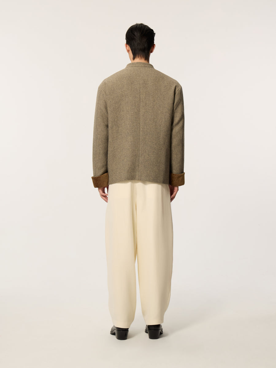 A long-sleeved, collarless coat in traditional Chinese style